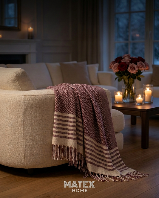 Roselle Bordeaux Throw draped on a sofa