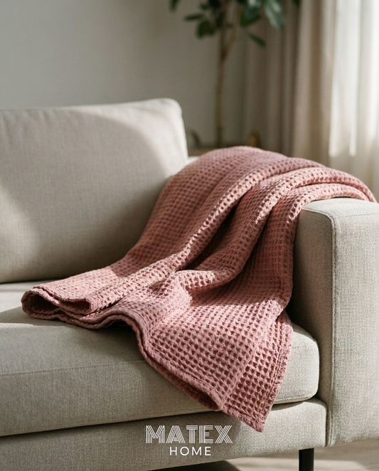 Waffle Cotton Blanket draped on a sofa