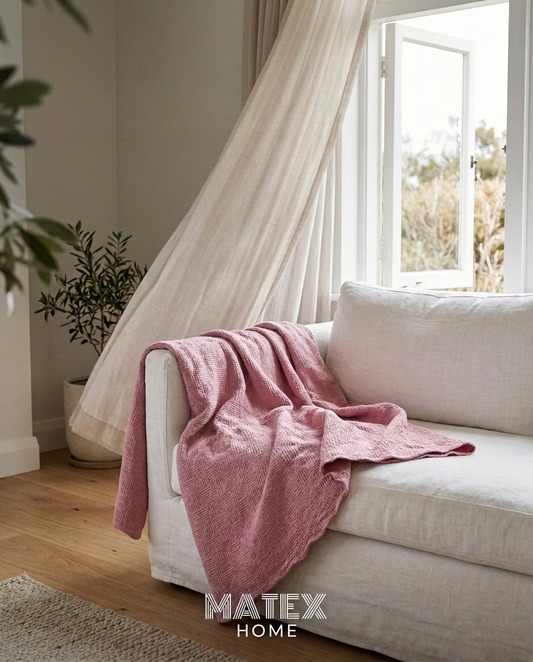 AirWeave Cotton Pique Blanket draped on a sofa