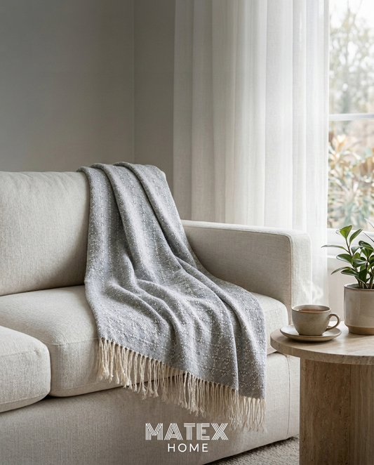 Mist Trellis Throw draped on a sofa