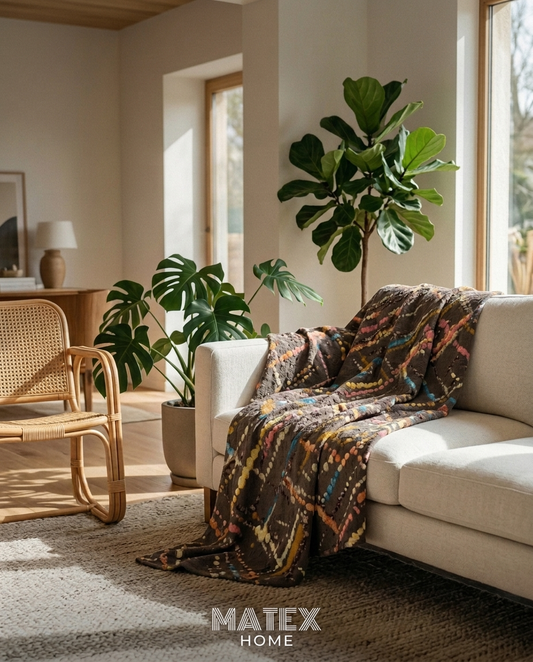 Tribal Splash Pique Blanket draped on a sofa