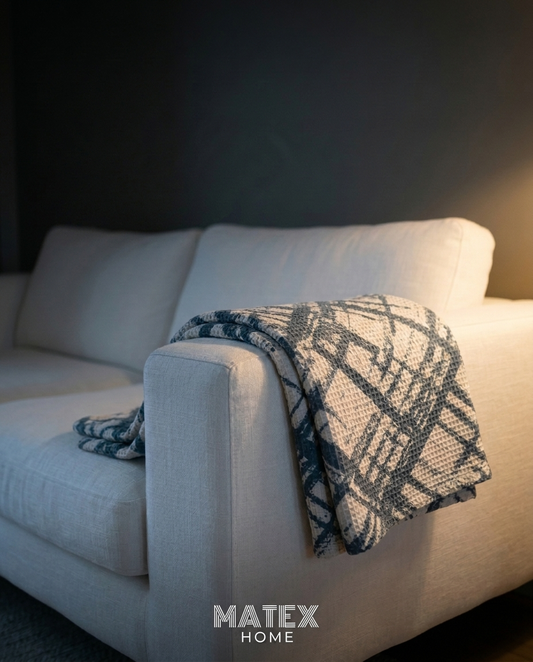 Slate Grid Waffle Blanket draped on a sofa