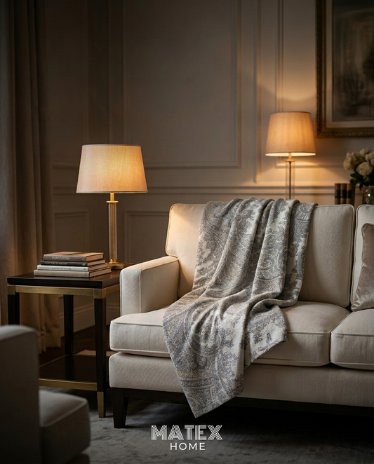 Imperial Paisley Pique Blanket draped on a sofa