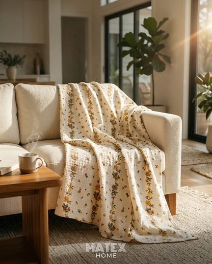 Golden Trellis Pique Blanket draped on a sofa
