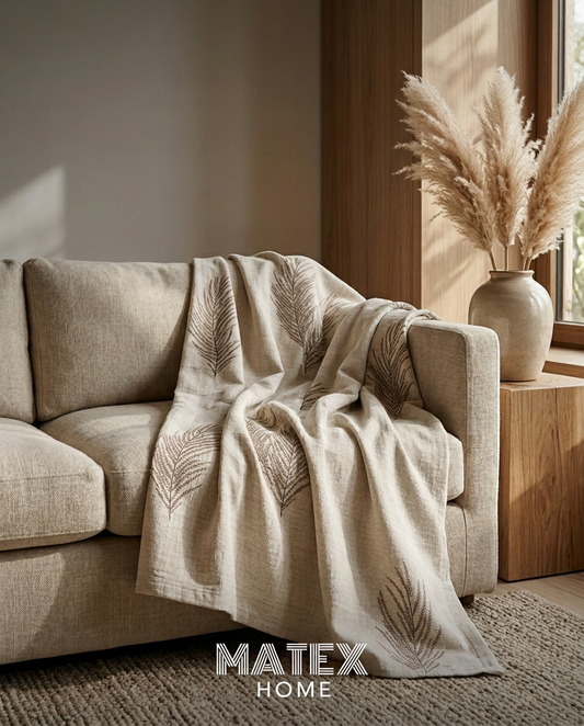Sand Fern Pique Blanket draped on a sofa